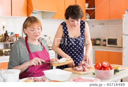Woman and mother making meat eating Woman and mother making meat eating 93716489