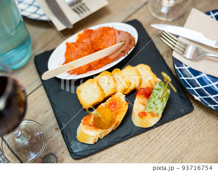 Spanish Cuisine. Variety of tapas on black stone Spanish Cuisine. Variety of tapas on black stone 93716754