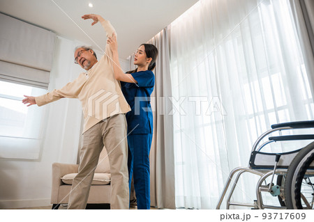 Old senior man enjoys training with physiotherapist for outstretched arms at home Old senior man enjoys training with physiotherapist for outstretched arms at home 93717609