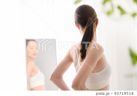 鏡をみて気にする女性 93719518