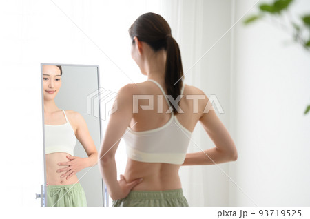鏡をみて気にする女性 鏡をみて気にする女性 93719525