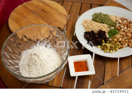 Close up shot a dish full of different seeds and nuts, chestnut,almond, raisin, pumpkins, seasame. Healthy eating concept Close up shot a dish full of different seeds and nuts, chestnut,almond, raisin, pumpkins, seasame. Healthy eating concept 93724451