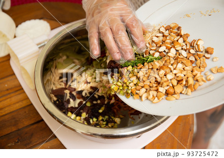 Female hands making dough for mooncake, homemade cantonese moon cake pastry on baking tray before baking for traditional festival. Travel, holiday, food concept Female hands making dough for mooncake, homemade cantonese moon cake pastry on baking tray before baking for traditional festival. Travel, holiday, food concept 93725472