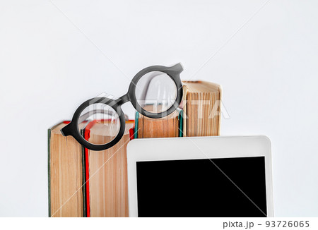 books, glasses and a tablet on a light background books, glasses and a tablet on a light background 93726065