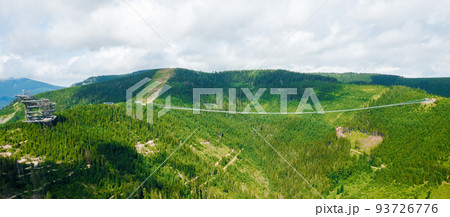 Aerial view of suspension Sky Bridge 721 and observation tower in mountains, Dolni Morava, Czech Republic. Aerial view of suspension Sky Bridge 721 and observation tower in mountains, Dolni Morava, Czech Republic. 93726776