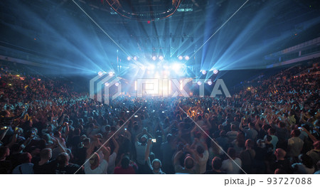 people at a concert are filming on a smartphone. people at a concert are filming on a smartphone. 93727088