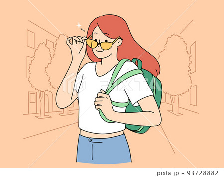 Smiling girl with backpack on street 93728882