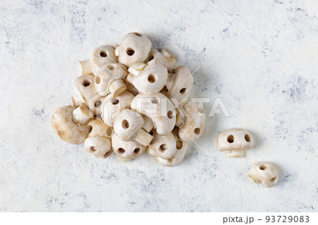 A bunch of raw champignon mushrooms in the form of skulls. Edible Halloween Concept 93729083