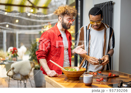 Two guys cooking healthy together at home 93730206