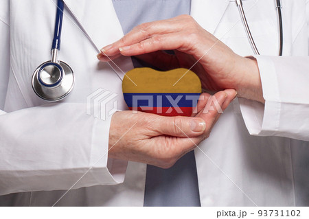 Colombian doctor holding heart with flag of Republic of Colombia background. Healthcare, charity Colombian doctor holding heart with flag of Republic of Colombia background. Healthcare, charity 93731102