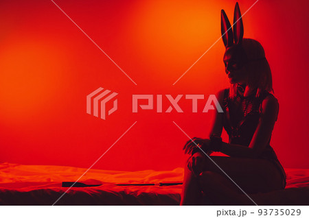 submissive sexy girl in underwear and a bunny mask sitting on the bed puts handcuffs on hands in bedroom submissive sexy girl in underwear and a bunny mask sitting on the bed puts handcuffs on hands in bedroom 93735029