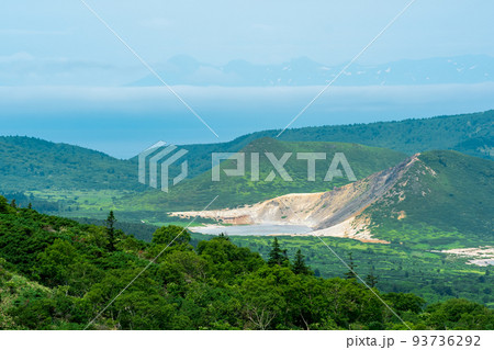 landscape of Kunashir Island, geothermal lakes among lava domes in the center of Golovnin volcano caldera; the island of Hokkaido is visible in the distance in the sea landscape of Kunashir Island, geothermal lakes among lava domes in the center of Golovnin volcano caldera; the island of Hokkaido is visible in the distance in the sea 93736292