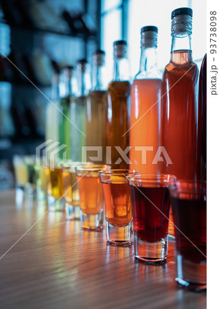 collection set of colored alcohol tincture or liquor with shot glass and bottles collection set of colored alcohol tincture or liquor with shot glass and bottles 93738098