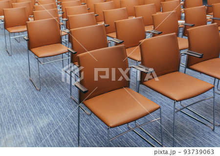 large empty conference room with orange chairs before the auction 93739063