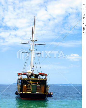 Beautiful vintage retro sailing ship sails on the sea against the blue sky 93739304