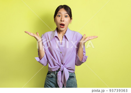Shocked Korean Woman Looking At Camera Standing Over Yellow Background 93739363