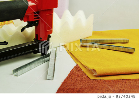 concept of furniture production and repair. Stapler and staples, working tool 93740349
