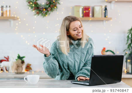 Business woman working at home on laptop during Christmas and New Year, happy and successful making a video call to colleagues and friends Business woman working at home on laptop during Christmas and New Year, happy and successful making a video call to colleagues and friends 93740847
