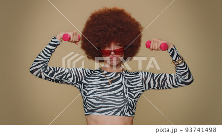 Woman working out, pumping up arm muscles lifting pink dumbbells, practicing pilates, healthcare 93741498