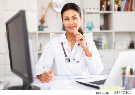 Portrait of female doctor in hospital interior Portrait of female doctor in hospital interior 93747303