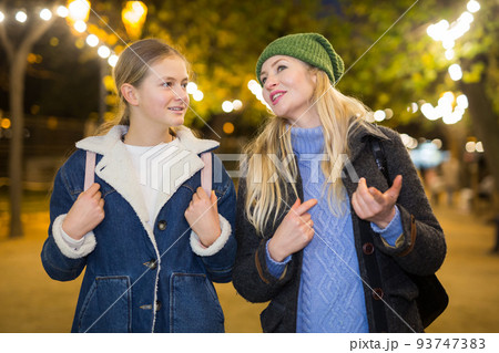 Portrait of mother with daughter at christmas street fair 93747383