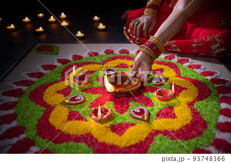 Traditional diya lamps lit during diwali celebration Traditional diya lamps lit during diwali celebration 93748366