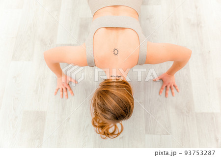 Young sporty woman, fitness instructor in sportswear doing stretching and pilates on yoga mat in the studio with mirror. Female fitness yoga routine concept. Healthy lifestyle and harmony. 93753287