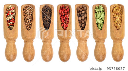 mix of spices in wooden scoop isolated on a white background. Top view. Flat lay. Set or collection 93758027