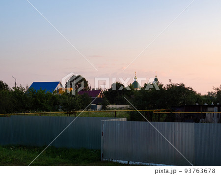 sunset sky over village in summer dusk 93763678