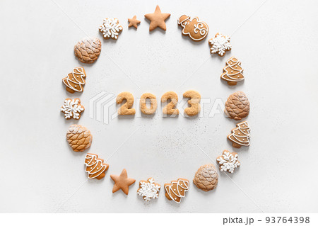 Christmas wreath of handmade cookies with date 2023. 93764398