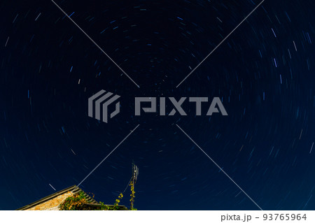 Star trails around North star on the night sky. 93765964