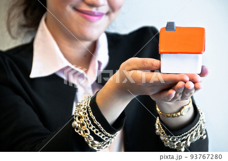House toy model is hold by business woman hand House toy model is hold by business woman hand 93767280