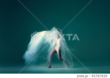 Contemp dance. Creative portrait of flexible ballet dancer in motion with white cloth over green blue background. Art, beauty, creation, inspiration concept. Contemp dance. Creative portrait of flexible ballet dancer in motion with white cloth over green blue background. Art, beauty, creation, inspiration concept. 93767839