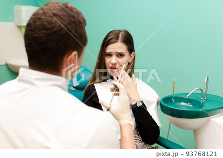 Dentist doctor holds an injection syringe. Girl has to make an analgesic injection. Woman is afraid of injections concept 93768121