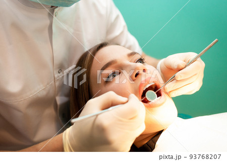 Young woman came to the dentist for examination. The dental doctor examines the patient close-up.. Young woman came to the dentist for examination. The dental doctor examines the patient close-up.. 93768207