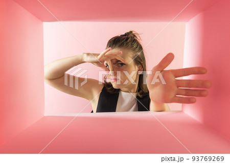 Young woman looking inside carton box and closing nose. Bad smelling inside Young woman looking inside carton box and closing nose. Bad smelling inside 93769269