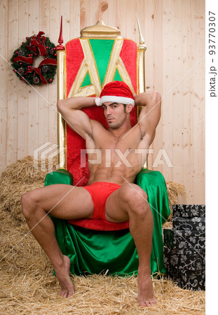 Sexy and muscled santa claus man in his armchair Sexy and muscled santa claus man in his armchair 93770307