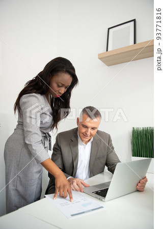 Business team of men and women in an office analyzing the evolution of the company 93771816