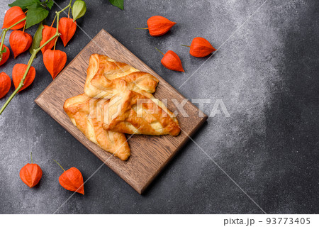 Delicious fresh cornmeal pastries with homemade cheese on a wooden cutting board Delicious fresh cornmeal pastries with homemade cheese on a wooden cutting board 93773405
