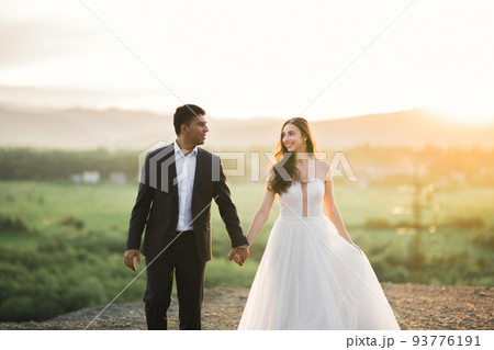 Wedding couple holding hands, groom and bride together on wedding day 93776191