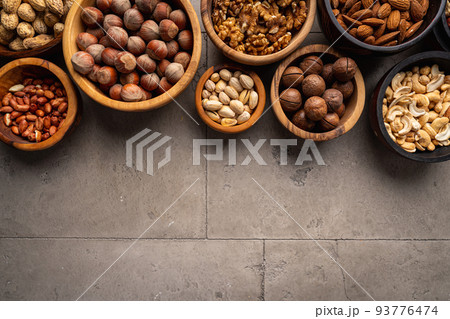 Assortment of nuts in bowls 93776474