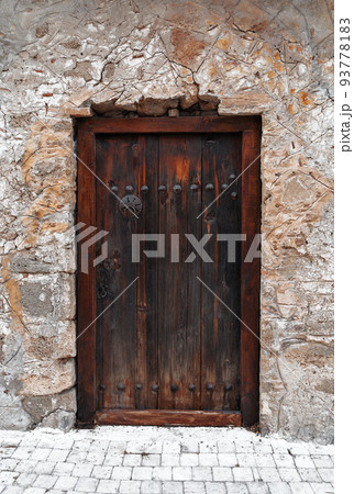 Closeup of dark wooden door with metallic brass vintage lion handles and decor for your design. Retro vintage style. Copy space. Textured background. Closeup of dark wooden door with metallic brass vintage lion handles and decor for your design. Retro vintage style. Copy space. Textured background. 93778183