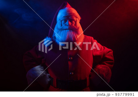 Santa Claus portrait in blue red neon light and smoke. Santa Claus portrait in blue red neon light and smoke. 93779991