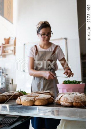 Finished French bread in the bakery on the table. Rustic bread, the crown of the Bordeaux kings. Front view. 93784496