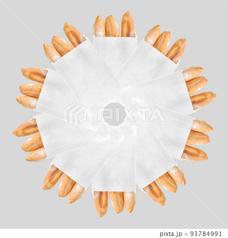 A French loaf in a white paper bag insulated on a white background. White bread in a craft bag. Geometric circular pattern of bread in a bag. 93784991