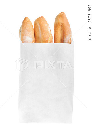A French loaf in a white paper bag insulated on a white background. White bread in a craft bag. A paper bag full of bread. 93784992