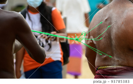 A man performs excruciating acts such as swinging on hooks pierced to the skin in the Kataragama Esala festival A man performs excruciating acts such as swinging on hooks pierced to the skin in the Kataragama Esala festival 93785383