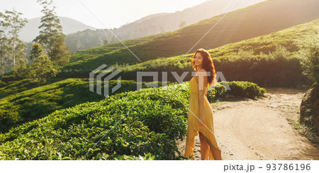 Woman Traveler Walk Against Tea Plantations Landscape Background in the Morning 93786196