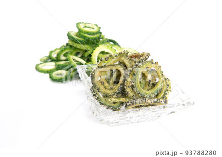 Homemade bitter gourd chips in glass bowl isolated on white background. Homemade bitter gourd chips in glass bowl isolated on white background. 93788280