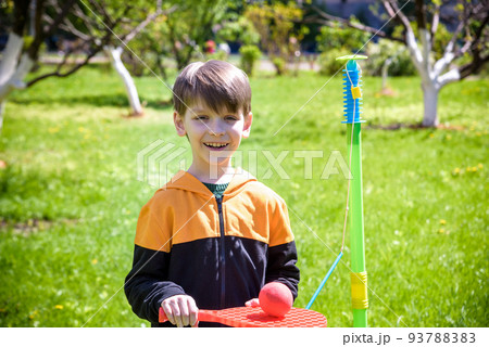 Happy boy is playing tetherball swing ball game in summer campin Happy boy is playing tetherball swing ball game in summer campin 93788383